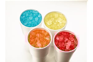 Four Styrofoam cups filled with brightly colored sodas and Hoshizaki Cubelet ice, viewed from above