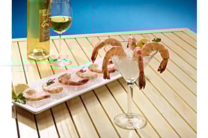 Shrimp cocktail and white wine displayed on a bed of Hoshizaki flaked ice on a white platter and in a martini glass