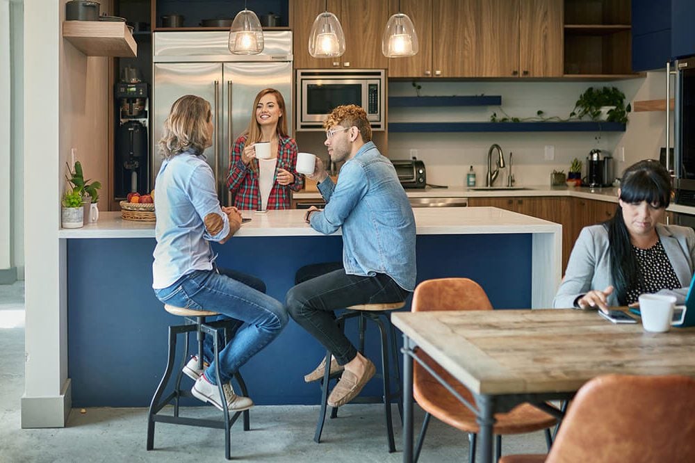 A Hoshizaki ice and water dispenser in a corporate office or commercial business breakroom